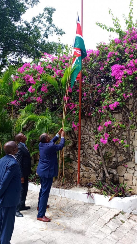 Kenya’s Consul General to Haiti, Noor Gabow, proudly raises the national flag at the Kenyan Consulate in Port-au-Prince, symbolizing the official launch of Kenya’s diplomatic presence in Haiti