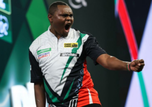 Kenyan Munyua Makes History As Van Gerwen Survives Scare At World Championship