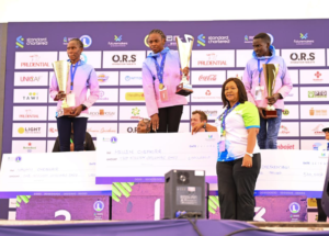 Standard Chartered Nairobi Marathon 42km women winner Hellen Chepkorir (middle) receives a dummy cheque from Tourism Cabinet Secretary Rebecca Miano along with Naomi Chepkorir (left) who clinched second position and Scholastica Chepkemboi third respectively.