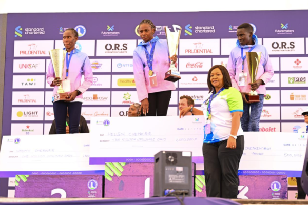 Standard Chartered Nairobi Marathon 42km women winner Hellen Chepkorir (middle) receives a dummy cheque from Tourism Cabinet Secretary Rebecca Miano along with Naomi Chepkorir (left) who clinched second position and Scholastica Chepkemboi third respectively.